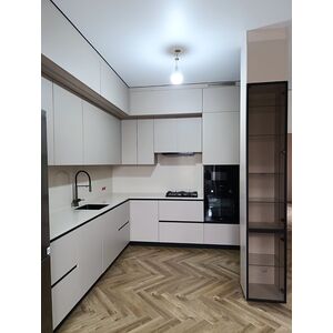 Угловая кухня в светло-серых тонах со стеклянным пеналом-витриной